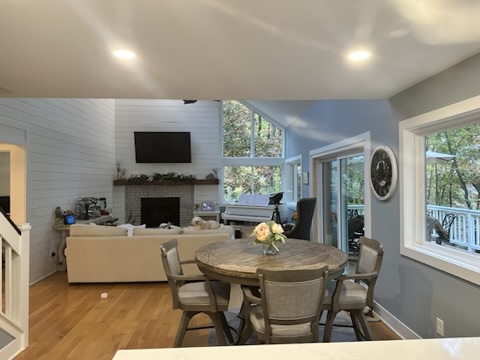 Renovated great room with shiplap accent wall, refinished fireplace, and light blue palette